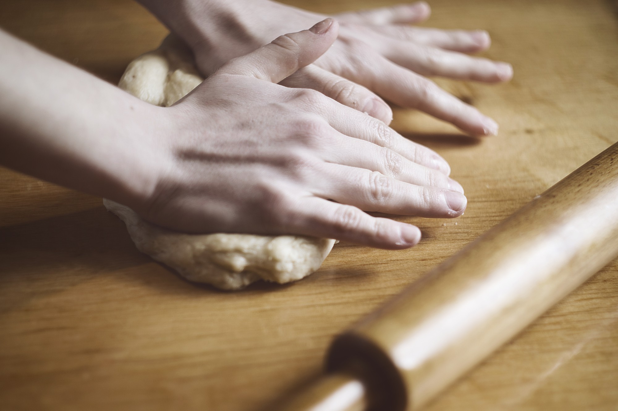 Close-up of hands kneading dough
